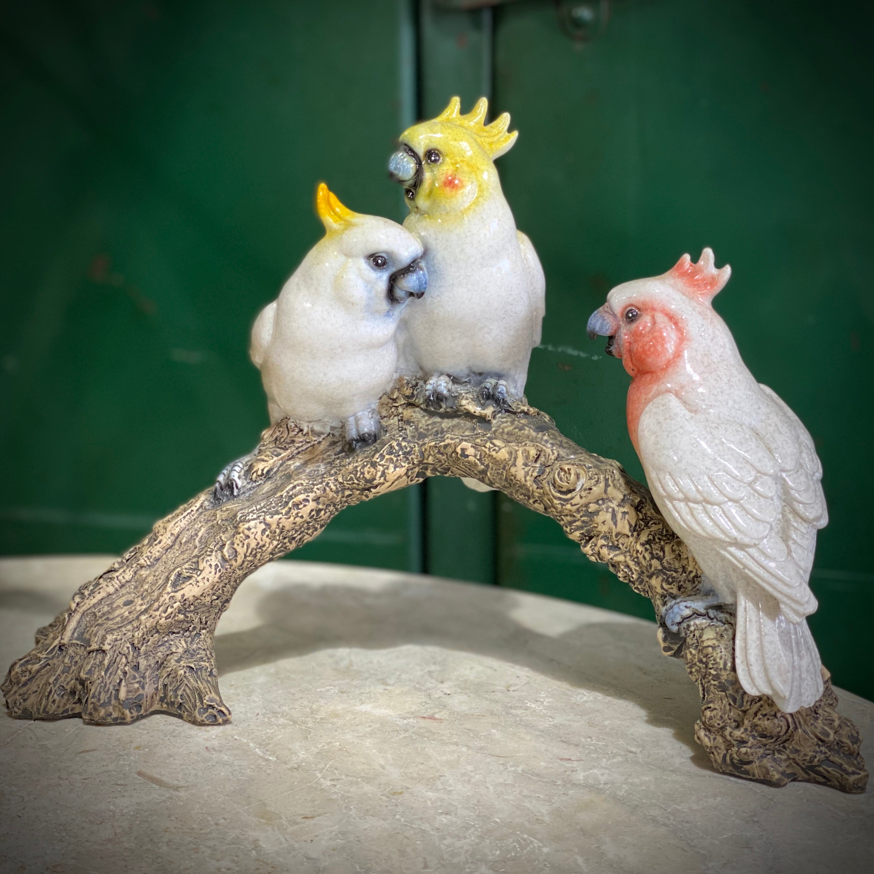 Trio of Porcelain Cockatoos on Log